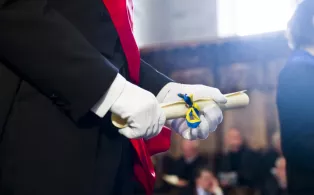 Hands holding a diploma